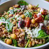 Colorful Mediterranean Farro Bowl featuring tender farro, spinach, Kalamata olives, and crumbled feta cheese.