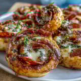 Warm, cheesy pizza pinwheels with pepperoni and herbs, perfect for appetizers, snacks, or party platters.