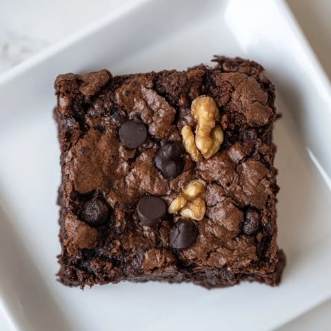 Warm, gooey brownies, fresh from the oven, offering a delightfully intense chocolate flavor.