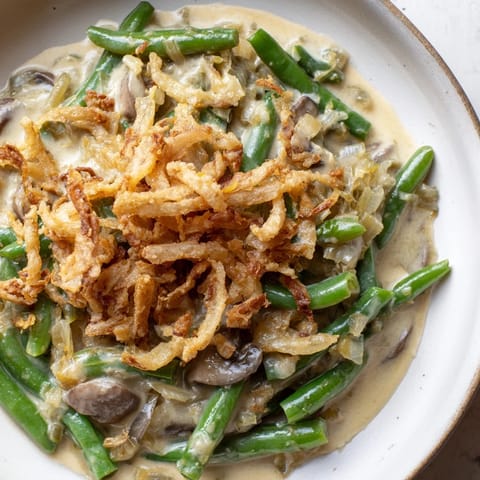 Golden brown Green Bean Casserole with a crispy onion topping, perfect for holiday meals.