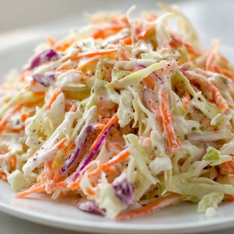 Fresh, crunchy coleslaw, a mix of shredded cabbage and carrots, ready for your BBQ.