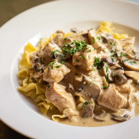 Tender chicken and earthy cremini mushrooms enveloped in a rich, tangy sour cream sauce served atop egg noodles.  