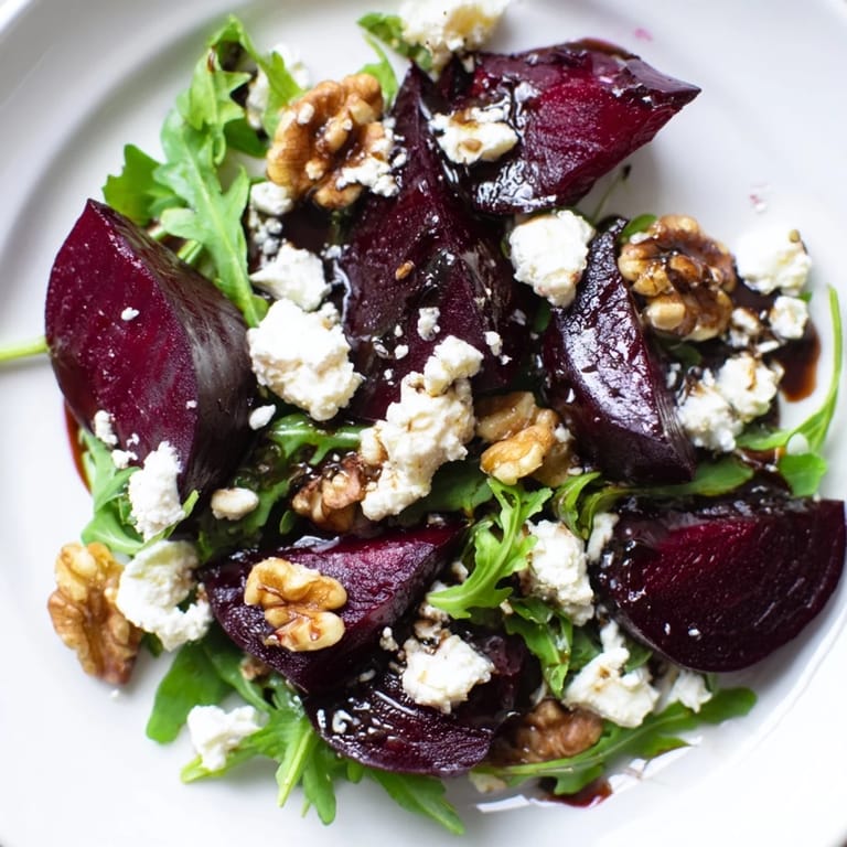 This vibrant roasted beet goat cheese salad features golden beets, creamy goat cheese, and toasted walnuts on arugula.