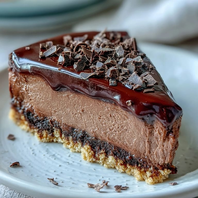 Fresh raspberries and a dollop of Greek yogurt garnish the creamy, rich dessert slice.  