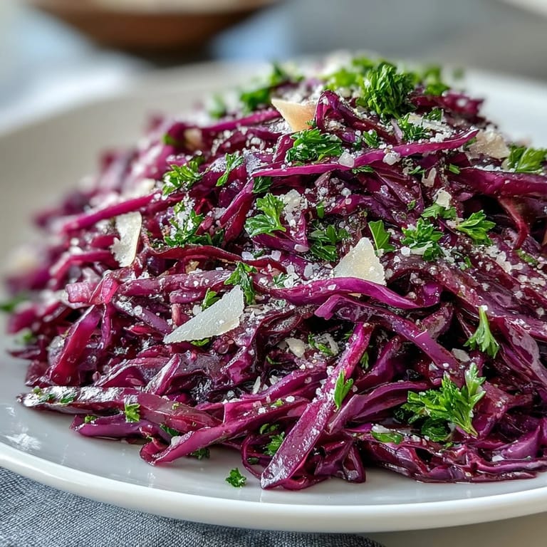 Shredded purple cabbage and green apple mix topped with salty Parmesan cheese.