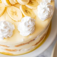 A layered Banana Pudding with creamy vanilla pudding, banana slices and whipped cream topping.