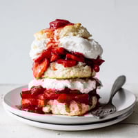 Warm strawberry shortcake, a delightful summer dessert, with juicy berries and whipped cream.