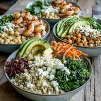 A vibrant Customizable Grain Bowl with roasted sweet potatoes, fresh cucumbers, and creamy avocado slices.